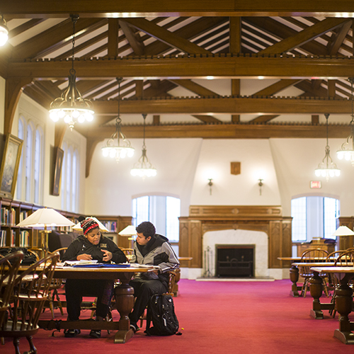 Two students study in the Red Room of Seymour Library. 