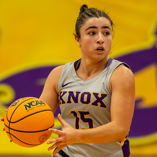 A player on the women's basketball team grabs the ball to run.