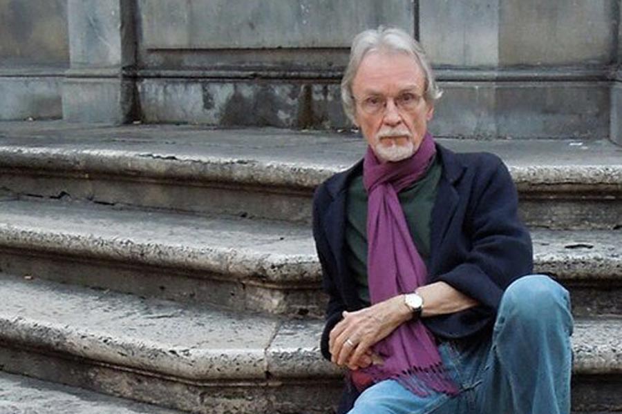 Robert Hellenga reclines on the steps of Piazza Santa Maria in Trastevere, Italy