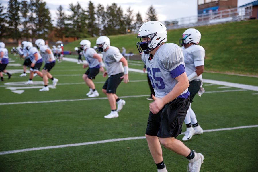 Football players line up for drills at the Knosher Bowl.