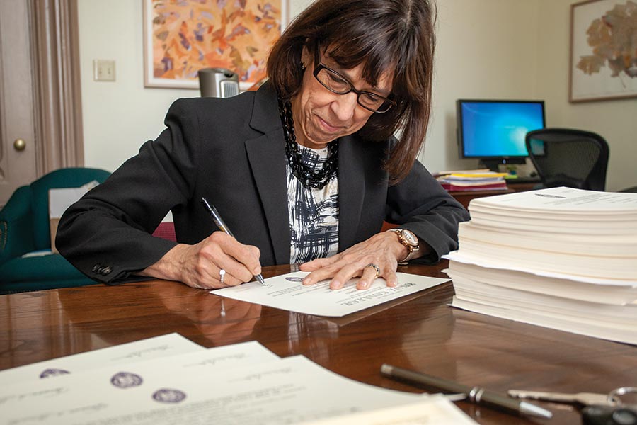 Teresa signs diplomas, 2016