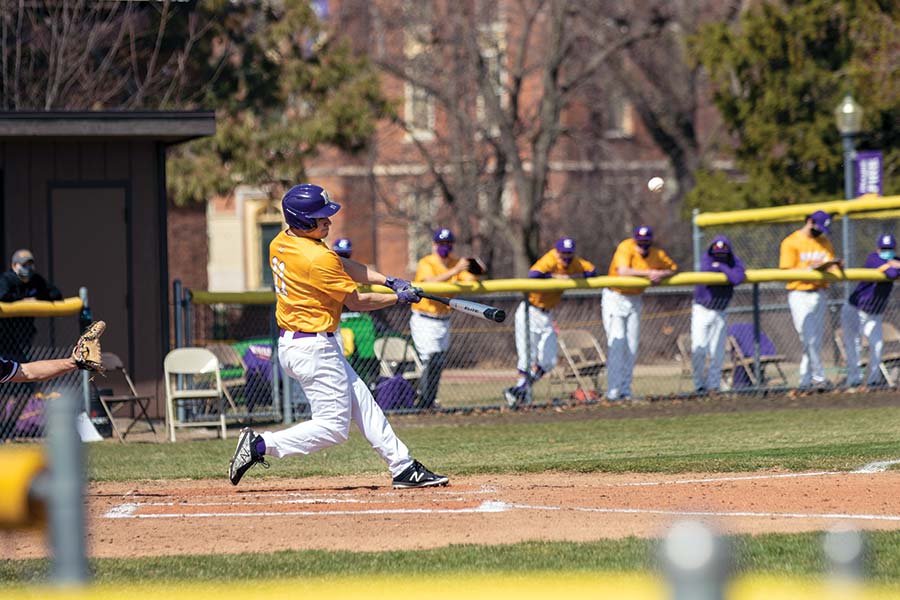 A Knox baseball player swings hard at a pitch during the team's first home game since 2019.