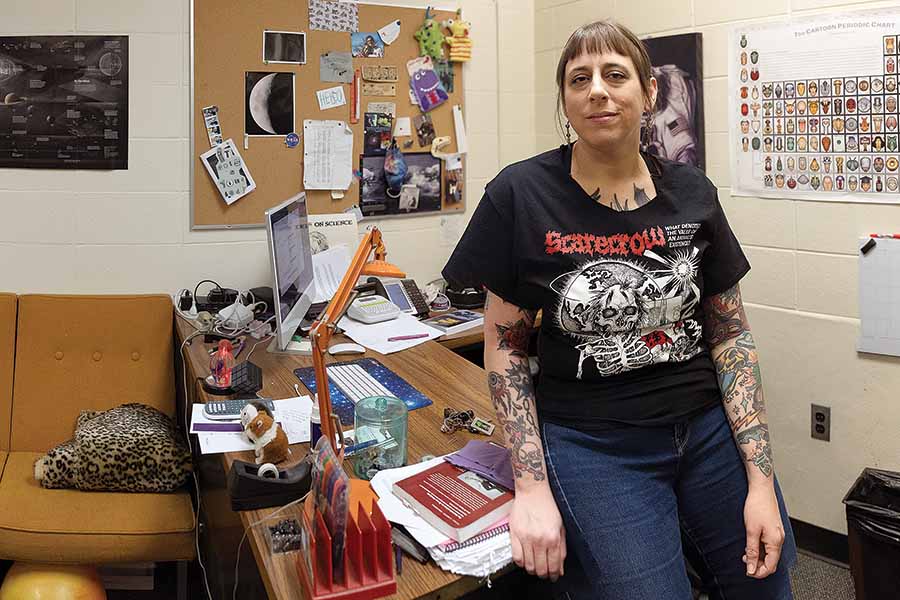 Nathalie Haurberg leaning against her desk in her office.