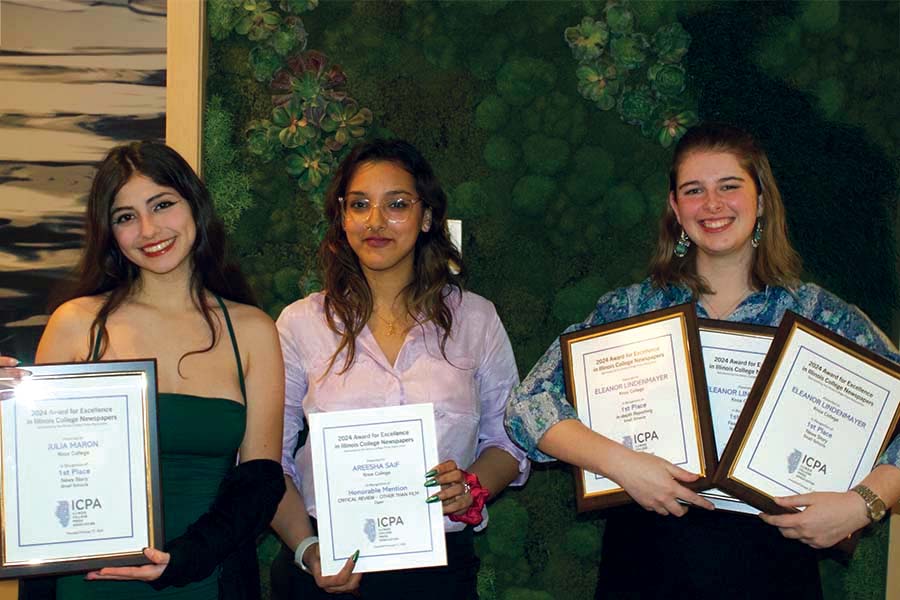 Students in TKS smile for the camera while holding their awards.