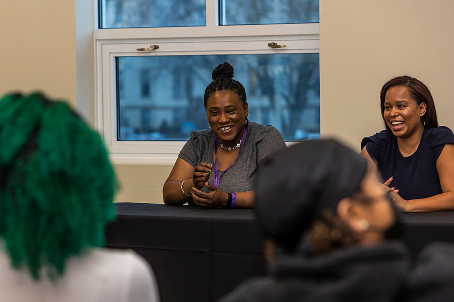 Knox alumni Rashanda Hassel '97 and Christina Aquino '10 laugh as they speak to students at a Black History Month panel 