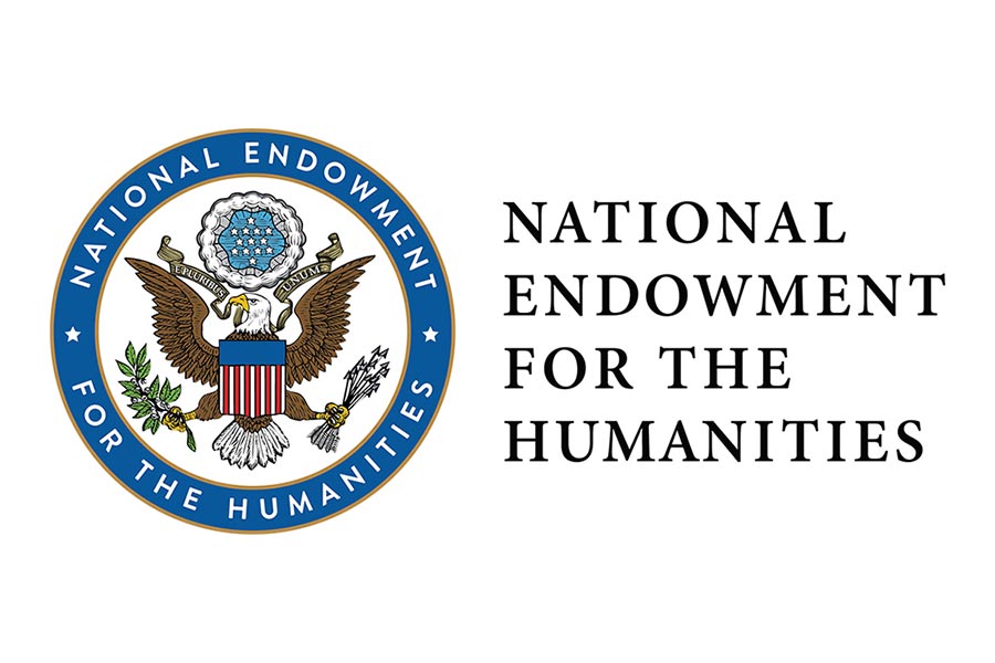 Circular seal, outlined in blue, with an eagle holding a red, white and blue shield. National Endowment for the Humanities.