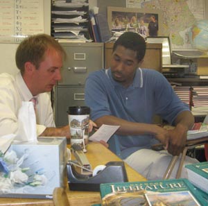 Brian Tibbets '96 counsels Dean Cliff '10. Cliff observed Tibbets' Latin class at Monmouth-Roseville High School during spring 2008.