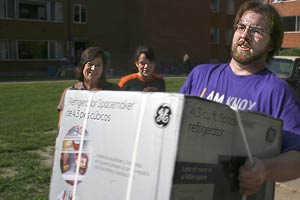 Loren Lindgren carries refrigerator for student