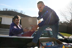 Employees load food donation