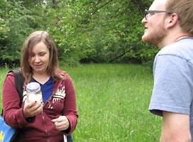 Students examine a trapped insect