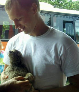 Matt McKinney holds a sloth