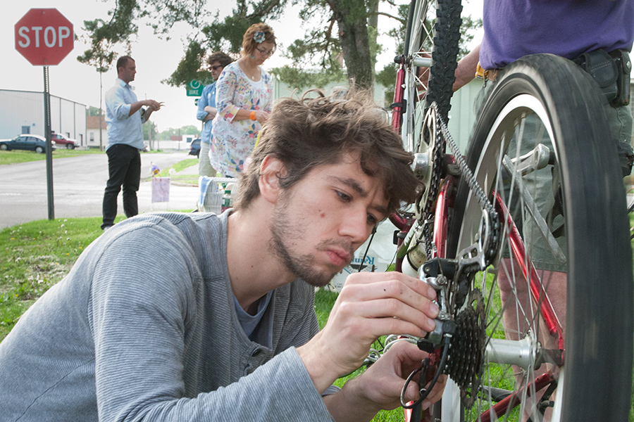 Knox Campus Bike Shop mechanic Colin Coutts adjusts a bicycle for Bike to Work Day, May 17, 2013. 