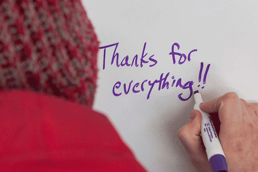 A student signs a card during Donor Thank You Days 2014.