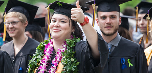 Students wear green ribbons at Commencement 2014