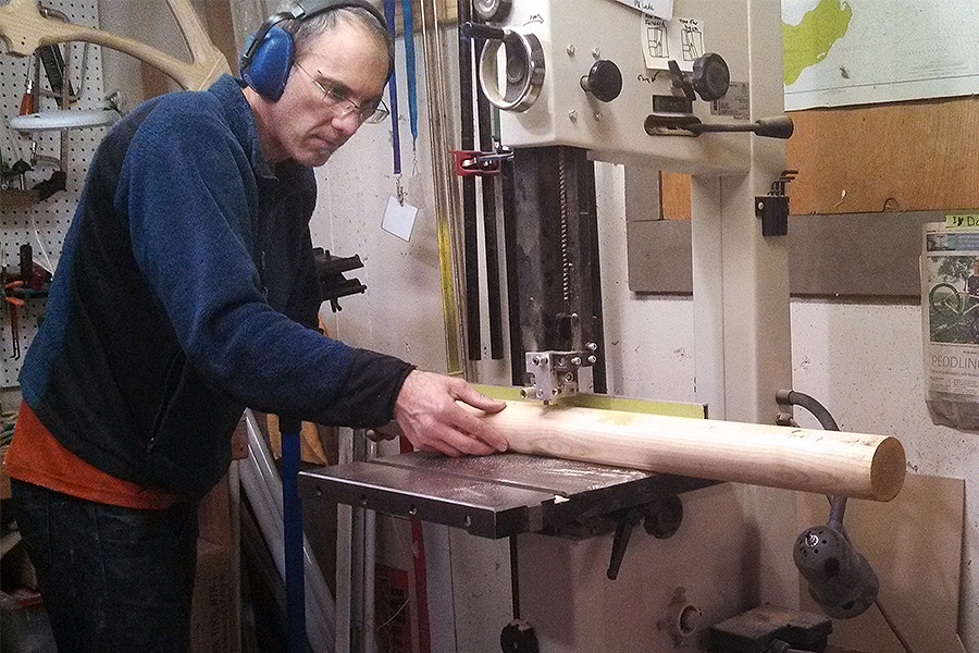 Knox College graduate Chris Connor building a wood frame bicycle at his company, Connor Wood Bicycles.