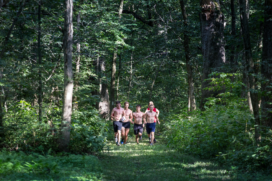 Knox College cross country teams, in preseason practice on forest trails at Green Oaks.