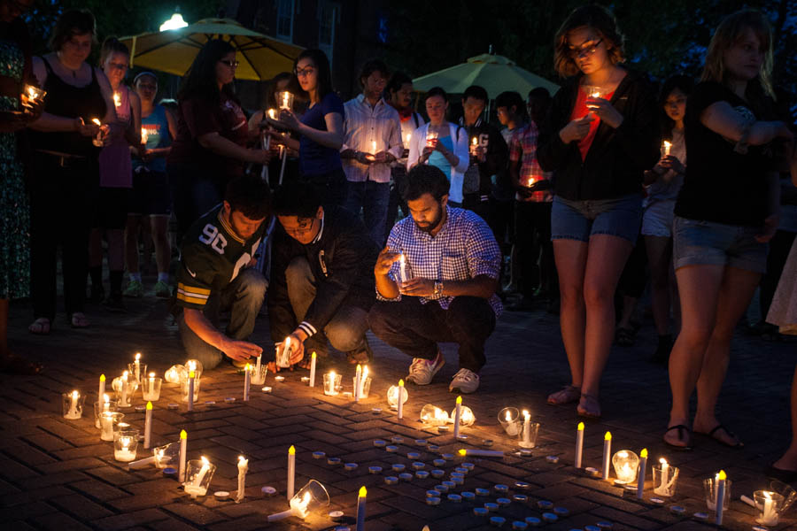 Knox College students light candles on the Gizmo Patio, as part of campus awareness and fundraising for Nepal earthquake relief during May 2015.