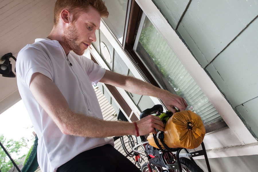 Cody Sehl prepares bicycle for cross-country trip, Galesburg to Denver.