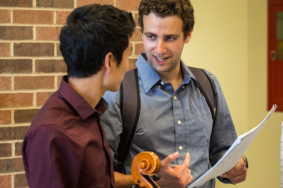 Knox students talk backstage before a perfomance of the string ensemble at the end of Spring Term 2015.