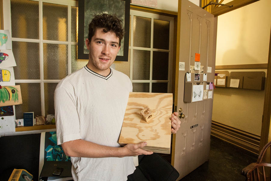 Oscar Hallas with wood box created to hold writing portfolio.