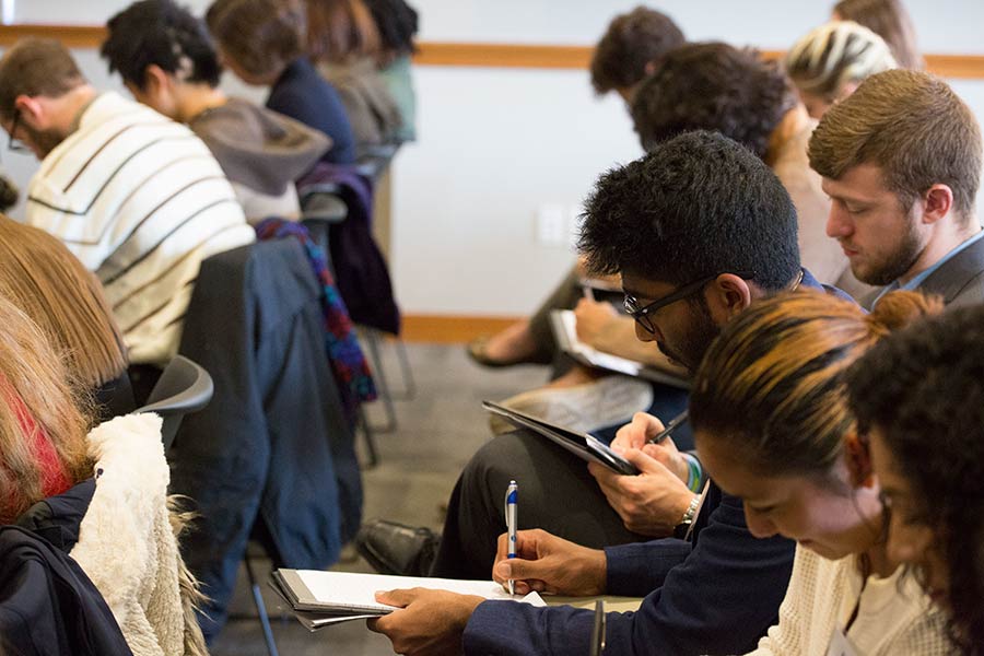 Students take notes at the Career Impact Summit.