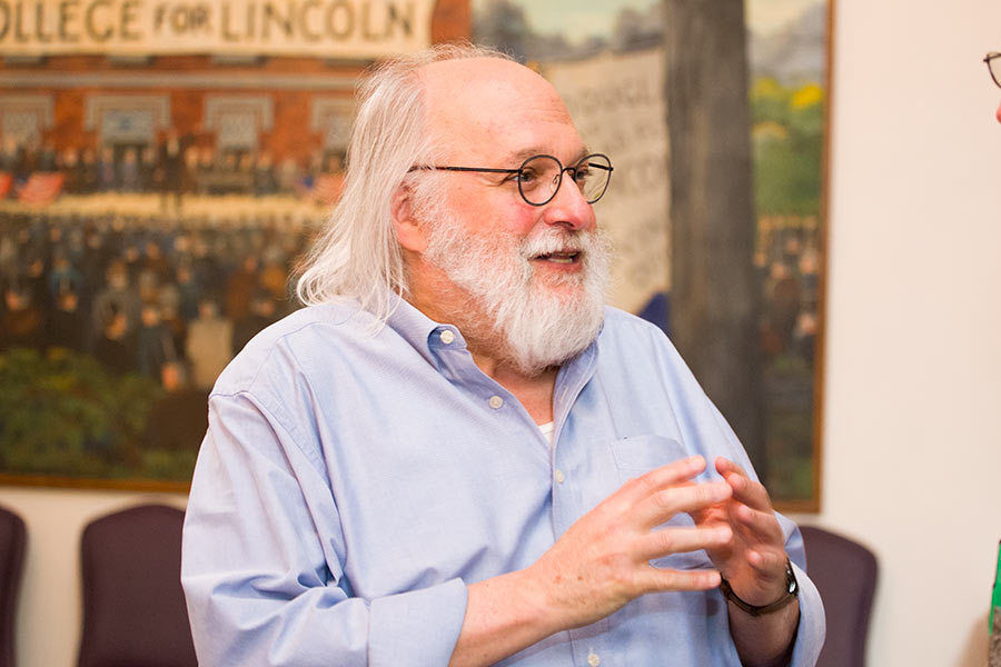 Professor of anthropology Larry Breitborde talks with faculty and friends at his retirement party.