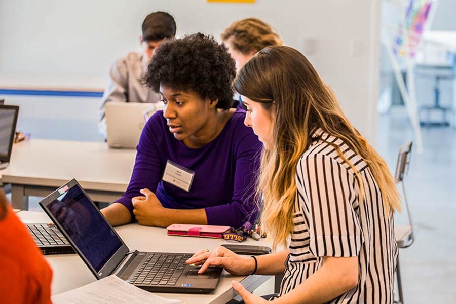 Students collaborate on the problem-solving component of the seminar, where groups must devise a strategy to save a failing company.