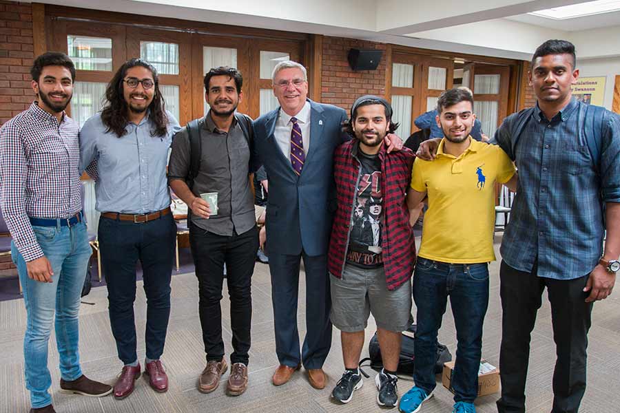 Barry Swason is congratulated by students at his retirement reception.