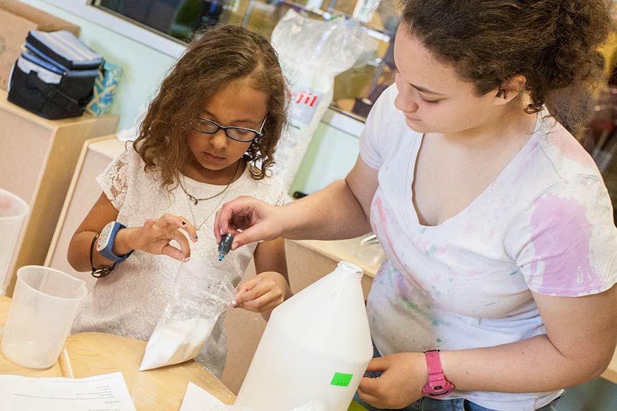 Members of the Knox College Chemistry Club work with area school children to teach them chemistry concepts