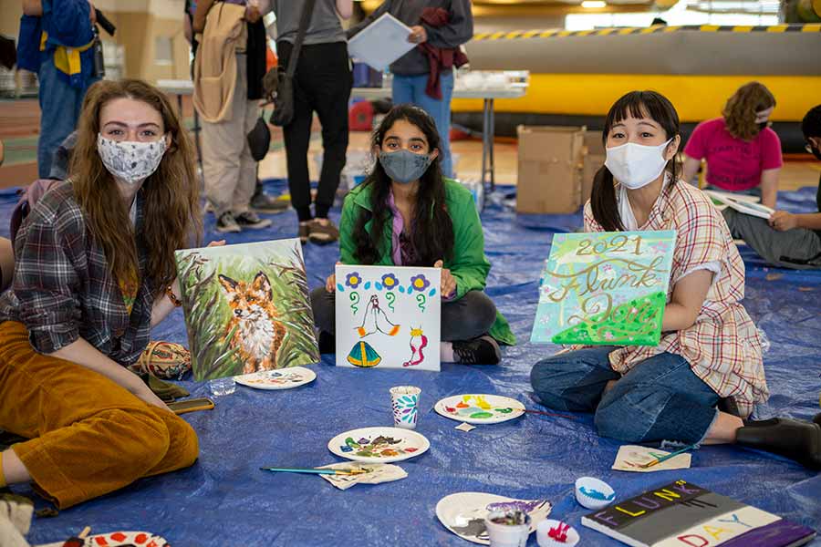 Students pose with paintings they made on Flunk Day 202.