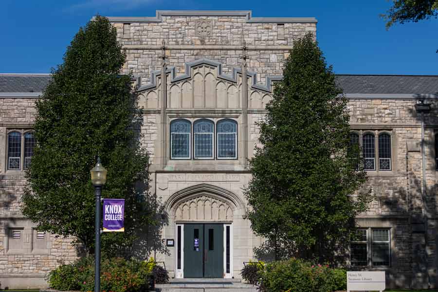 Trees stand on either side of the main entrance to Seymour Library at Knox College