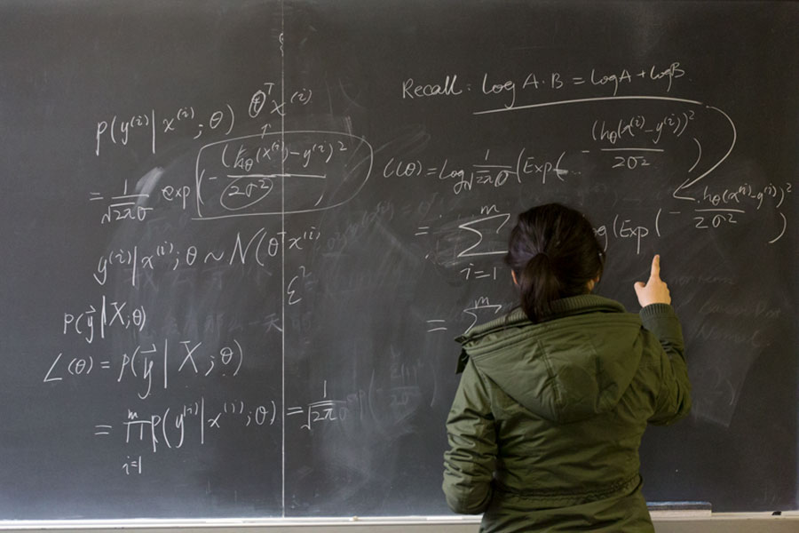 Writing math problems on the black board.