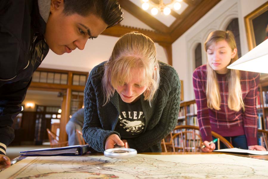 Students exploring a map.