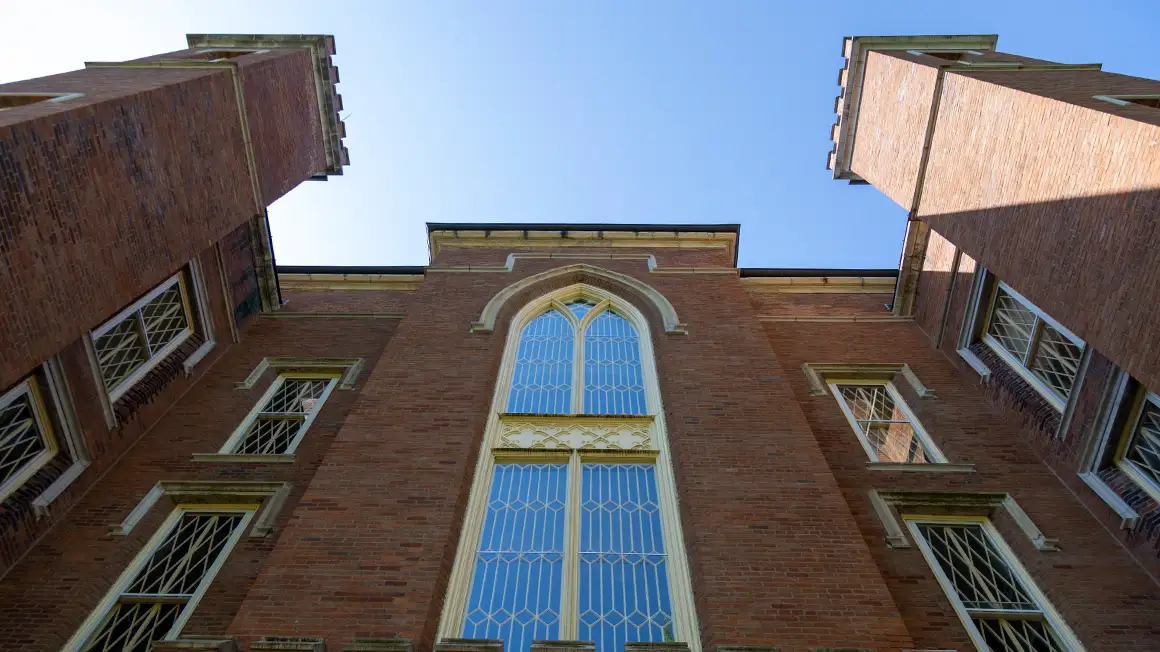 Looking up the north side of Old Main on the Knox College campus with a blue ski overheard.