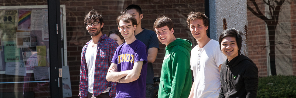 Students in a physics class, on a sidewalk outside.