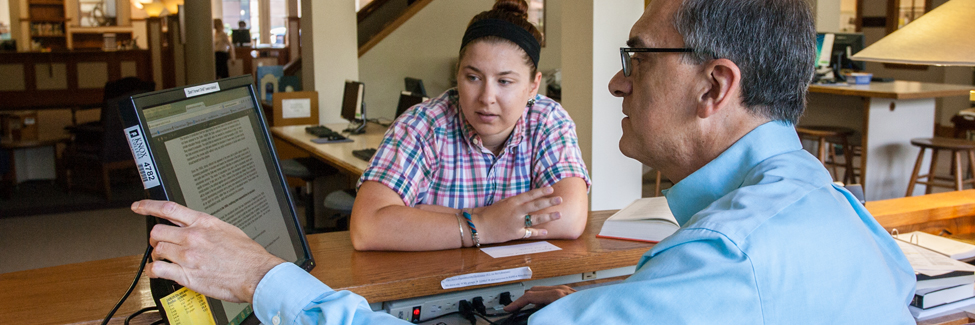 A student discusses her research with library director Jeff Douglas.