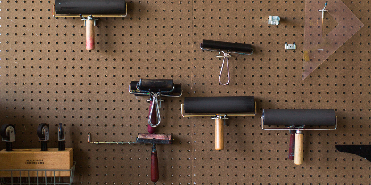 Print rollers on the wall in the print making room. 