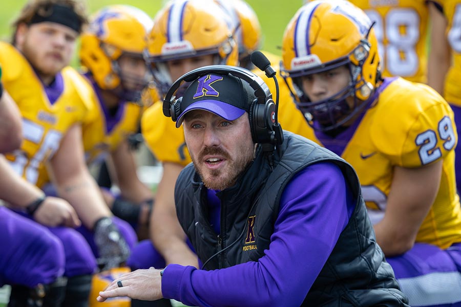 Image of Head Football Coach Aaron Willits '08 with the team